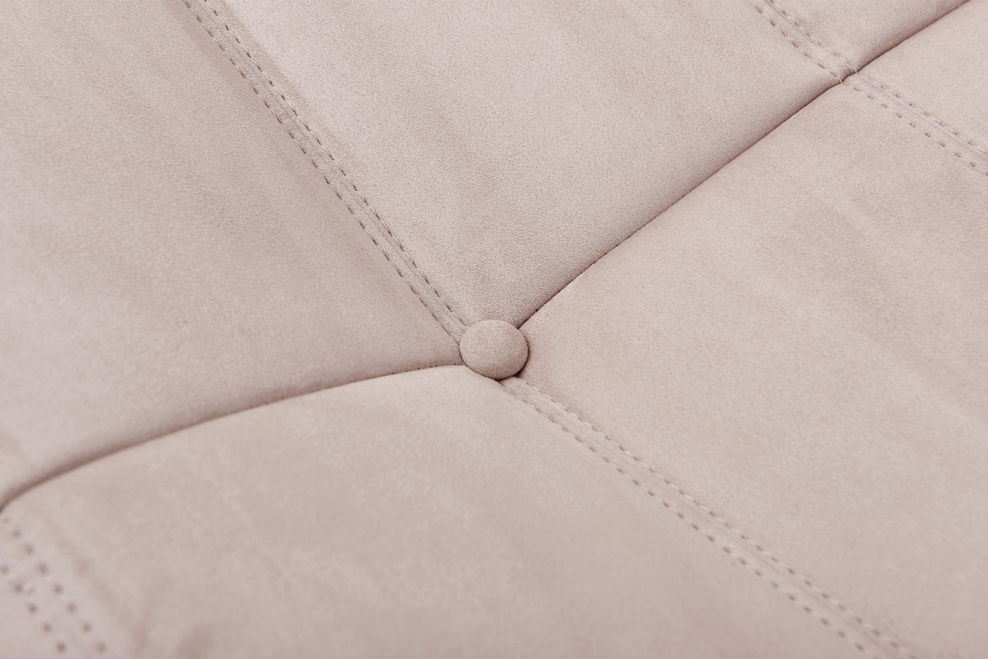 Macro detail shot of the button tufting and soft fabric texture on the TOGO Lounger.