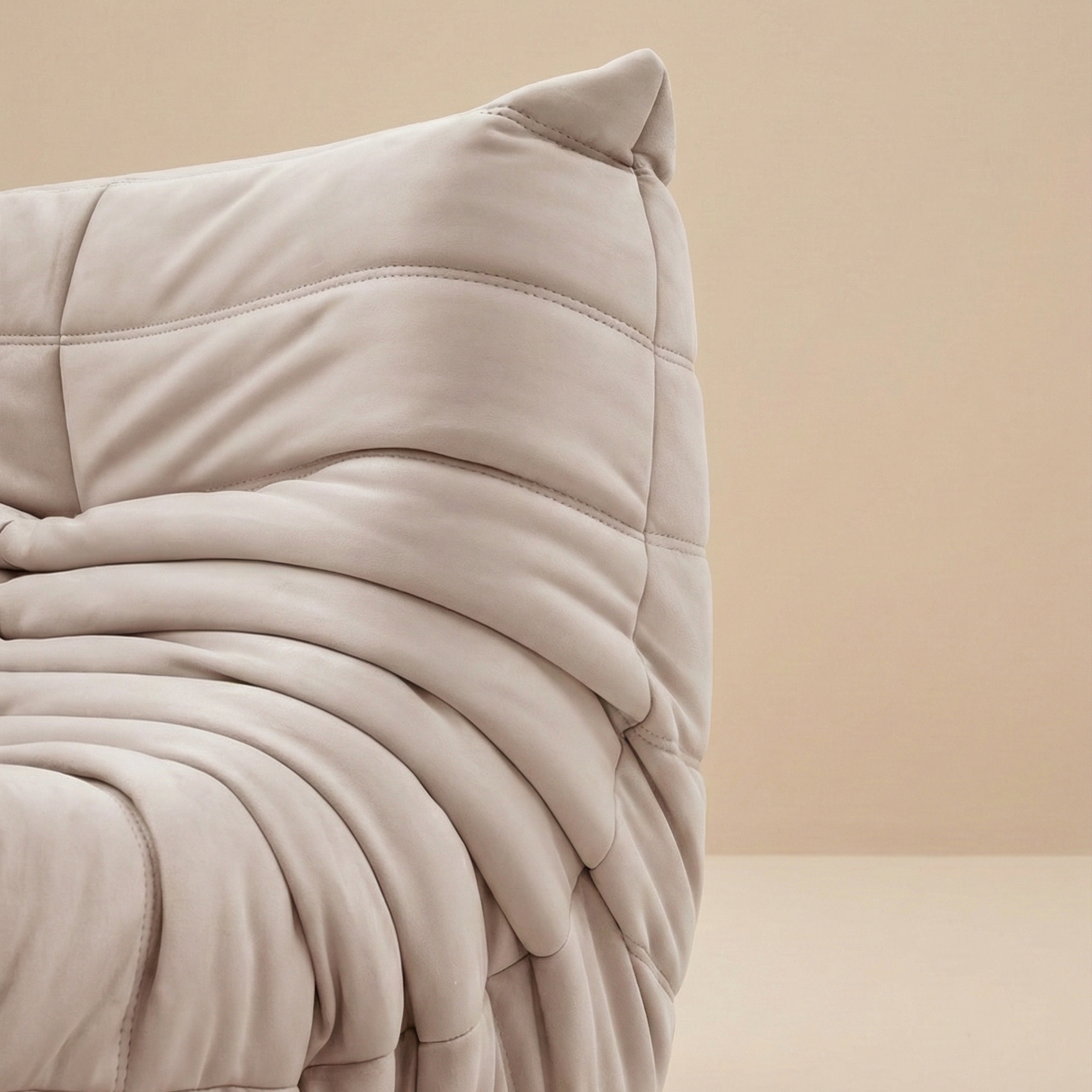 Close up detail of the pleated fabric folds and stitching on the corner of the TOGO Lounger sofa.
