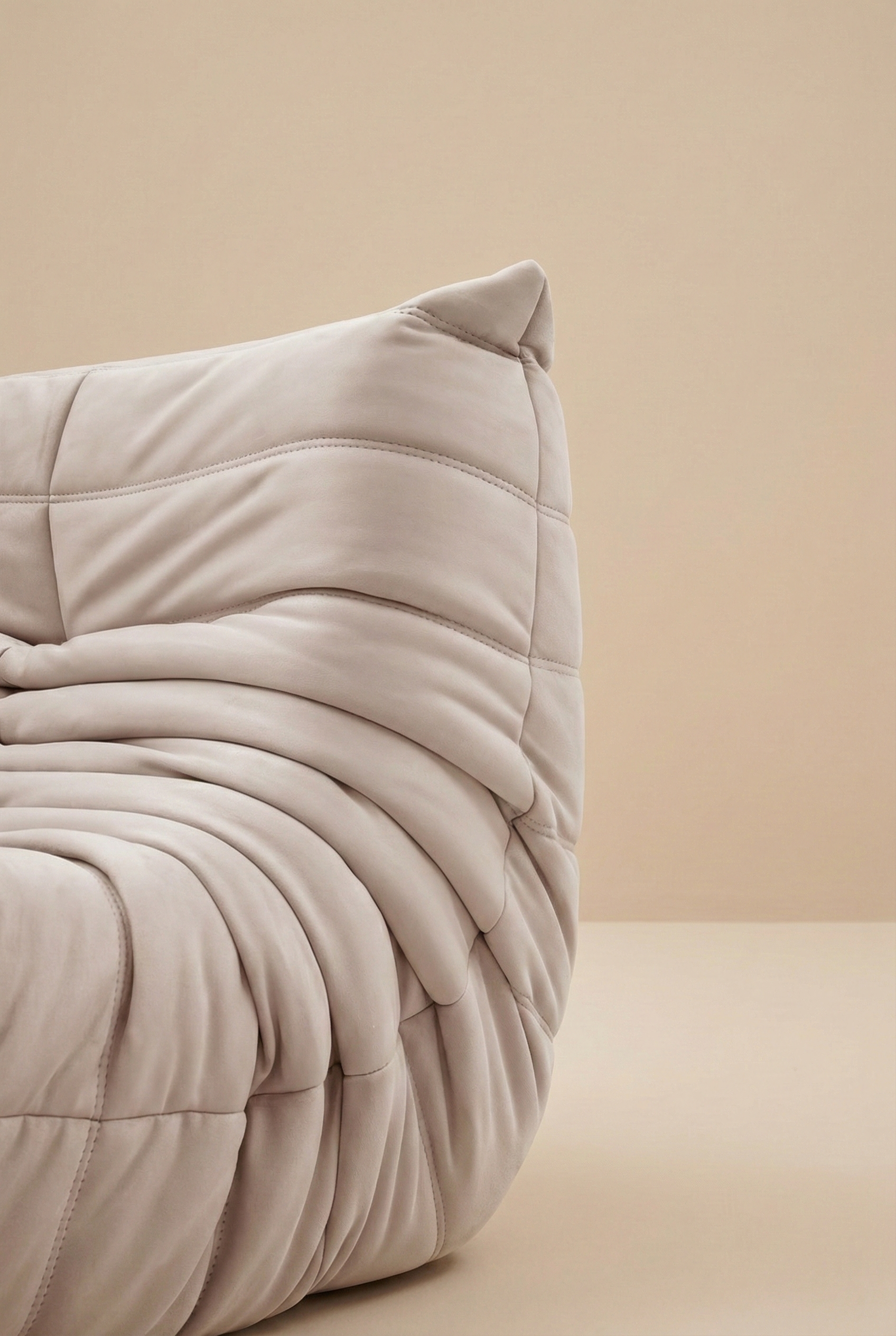 Close up detail of the pleated fabric folds and stitching on the corner of the TOGO Lounger sofa.