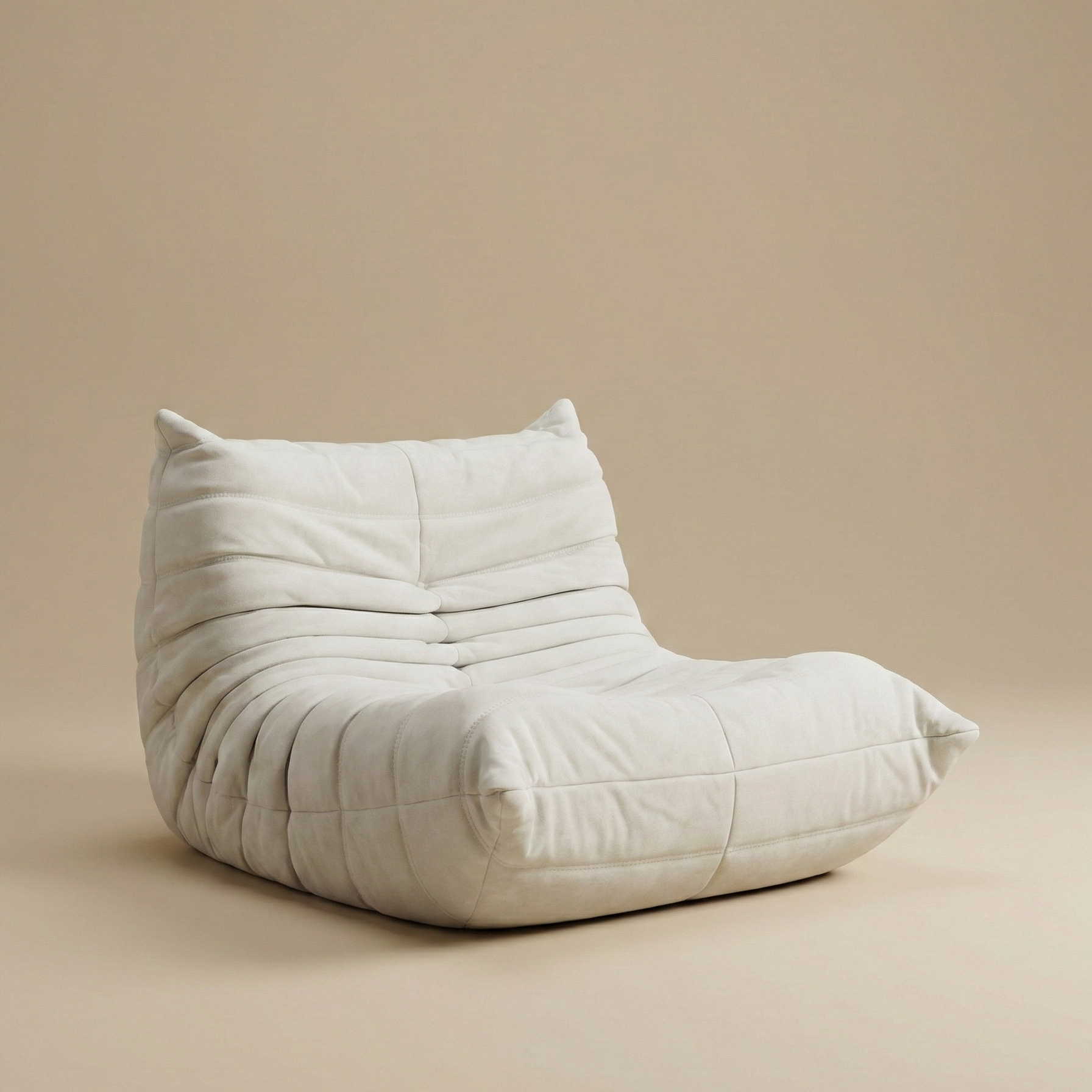 Angled view of the white TOGO floor chair showing ergonomic curved back and deep tufted folds.