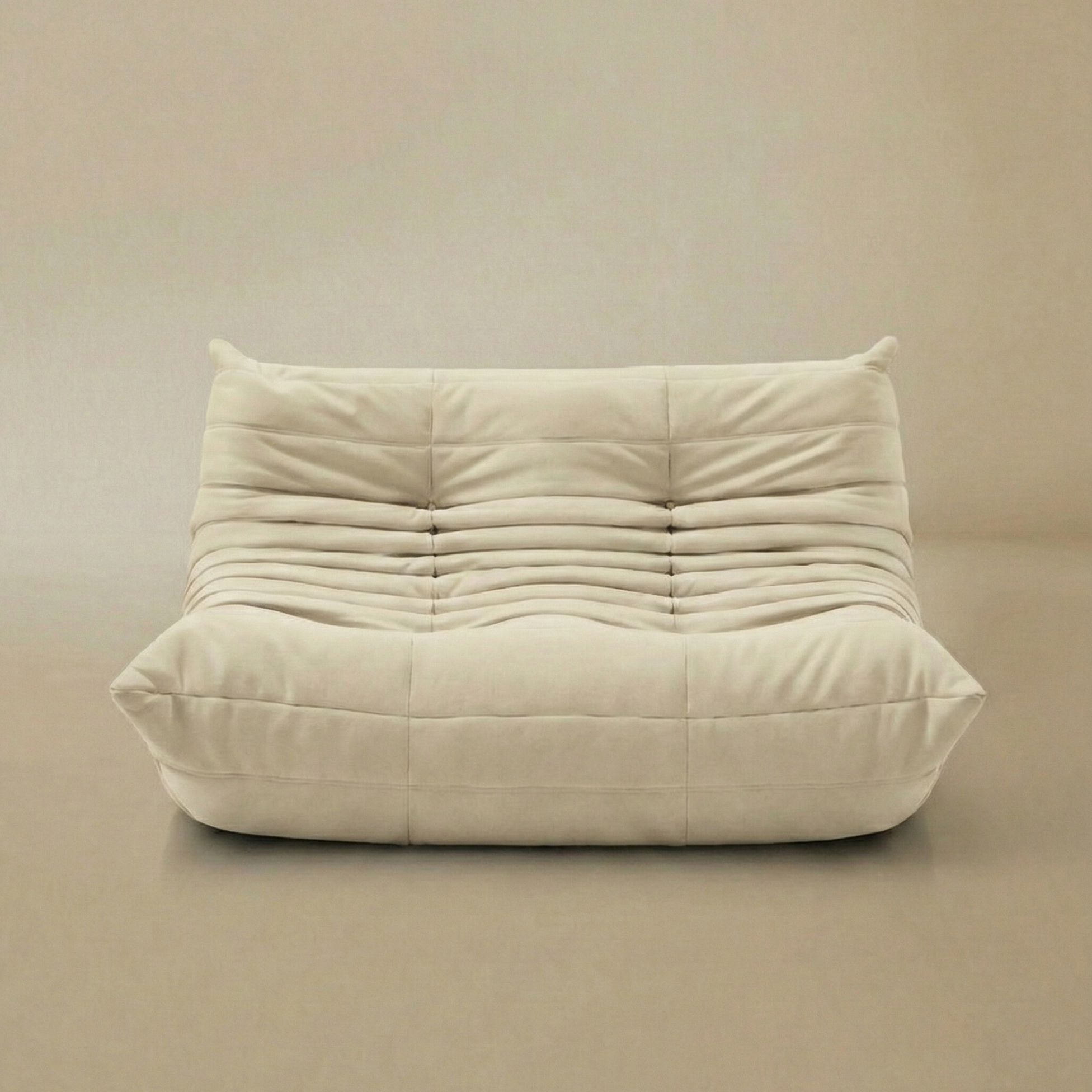 Front view of TOGO Lounger two-seater in cream velvet fabric with soft pleated texture.