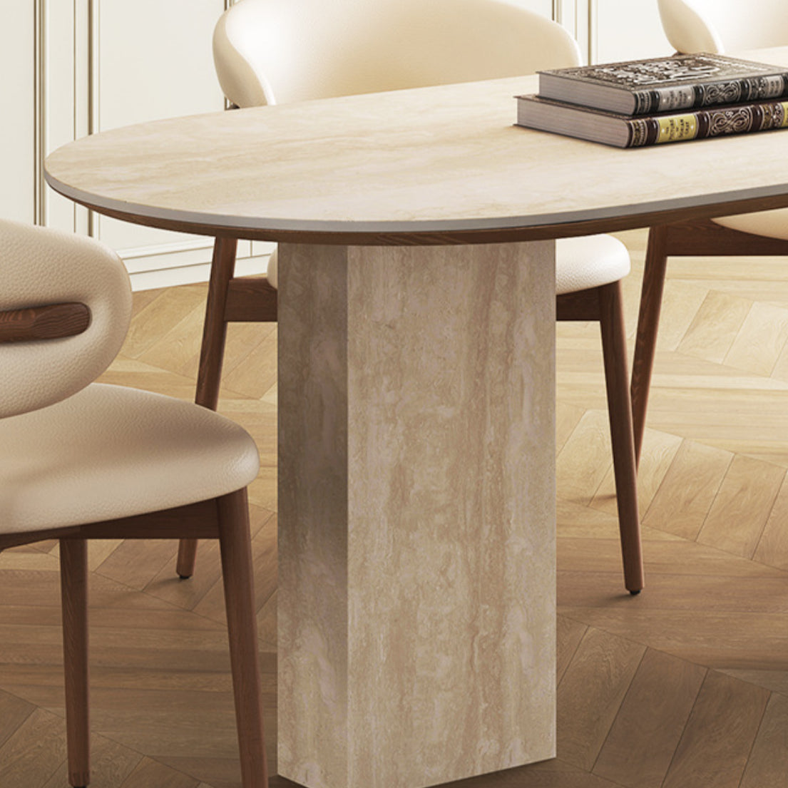 Close-up of travertine sintered stone dining table with rectangular stone leg and cream chairs on wood floor