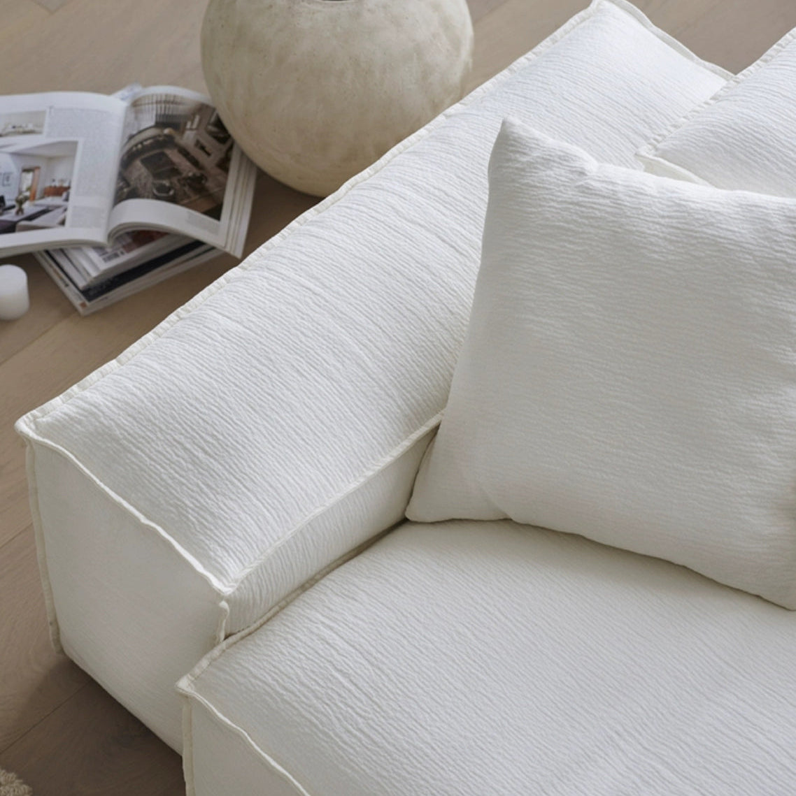 Whisper Breathable Cotton Sofa armrest and cushion close-up highlighting soft white breathable cotton muslin fabric and subtle texture in a modern living space