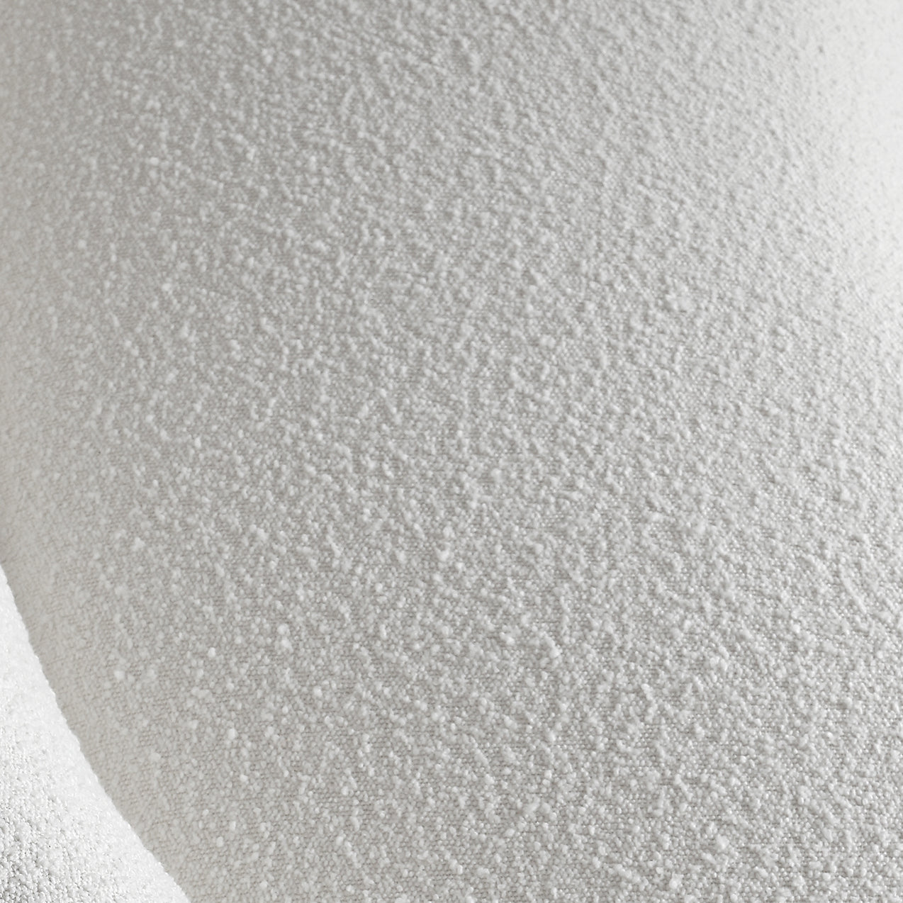 Close-up texture of white bouclé fabric showing soft, looped surface detail
