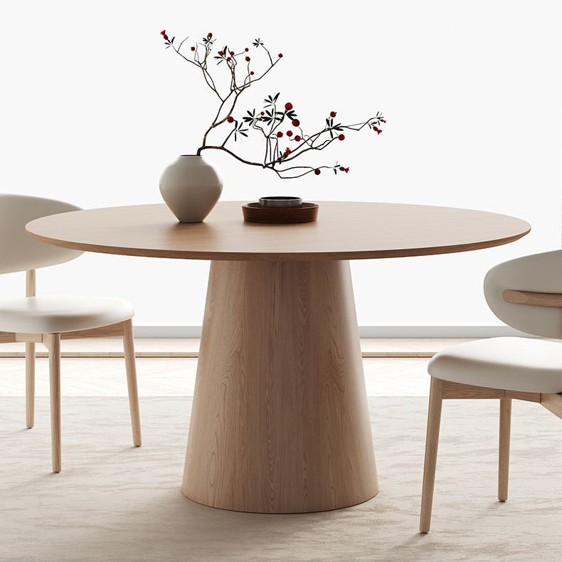 Close-up of Willow Ridge round dining table in solid ash wood with cream chairs and vase decor