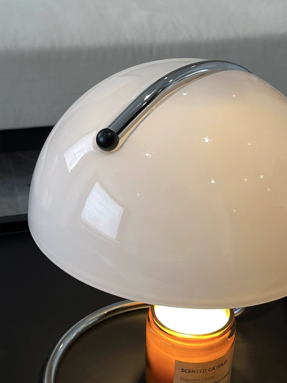 Close-up of Wooden Frame Modern Candle Warmer Lamp with dome shade warming a scented candle.