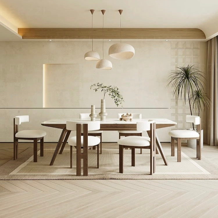 Bouclé Ash Wood Dining Chairs arranged around a modern wood dining table in a bright, neutral dining room with soft minimalist décor