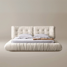 A luxurious beige upholstered Italian-style Cloud Bed with a high headboard and plush cushioning, resembling the softness of clouds.