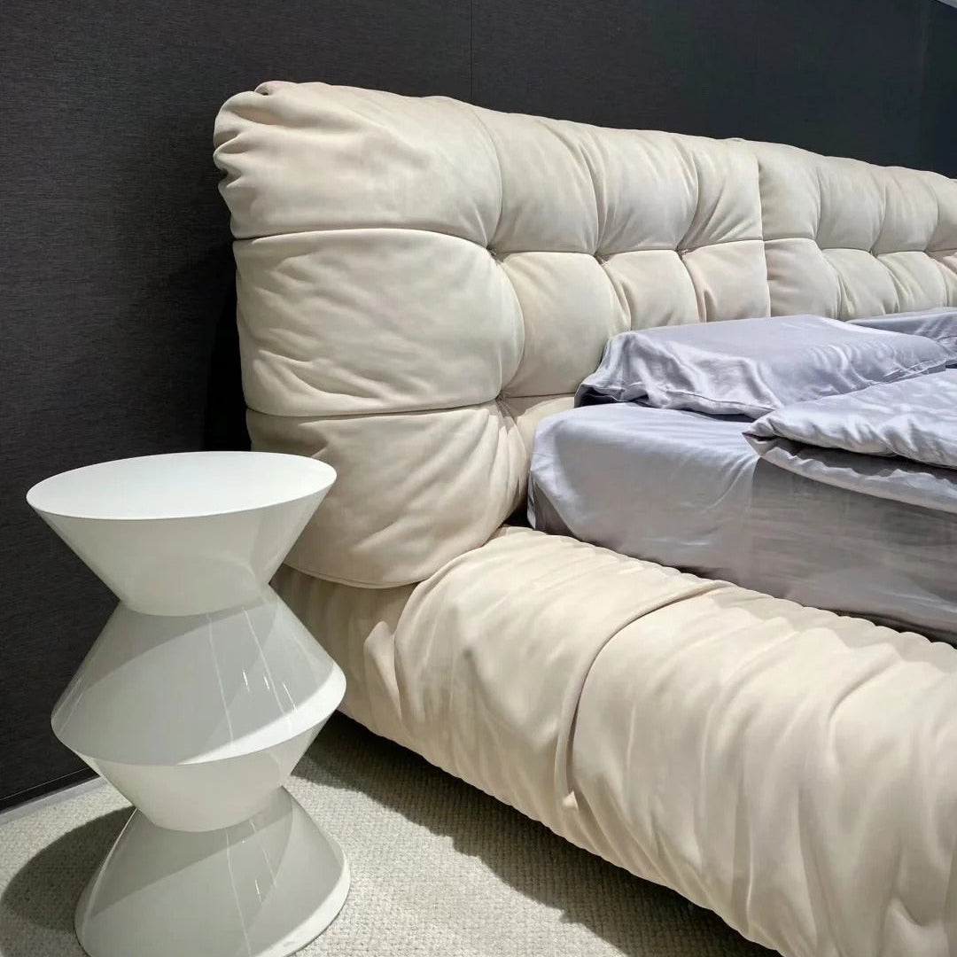A luxurious beige upholstered Italian-style Cloud Bed with a high headboard and plush cushioning, resembling the softness of clouds.
