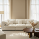 Modern living room with a white sofa, wooden coffee table, and decorative elements.