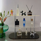 Acrylic Three-Tier Desktop Organizer displaying perfumes, reed diffuser, and decor on a vanity table