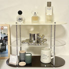 Acrylic Three-Tier Desktop Organizer with chrome supports, holding perfume, candles, and decor items