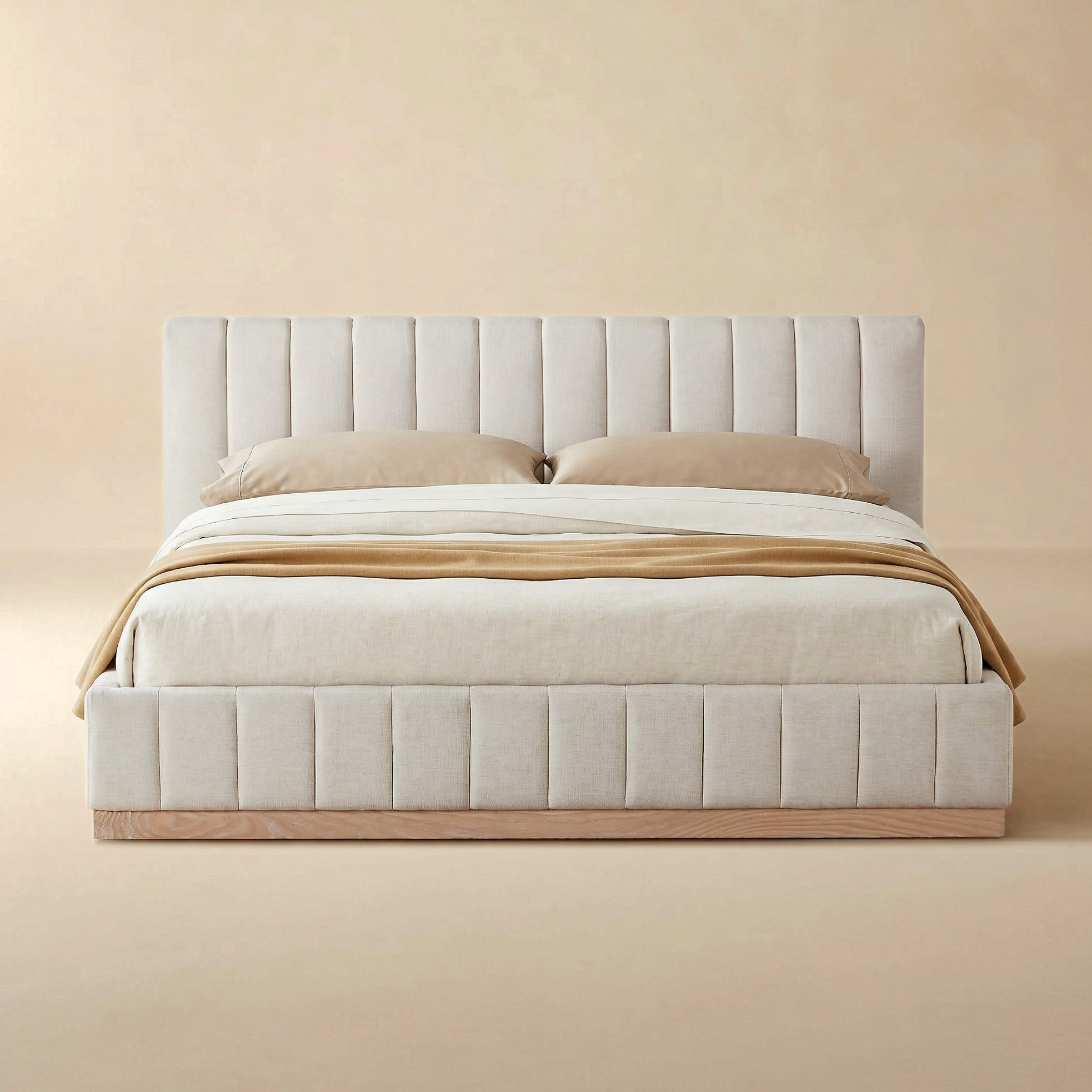 Beige upholstered bed with wooden frame against a beige wall