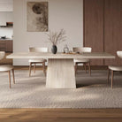 Ardella sintered stone dining table with trapezoid base styled in modern dining room with beige chairs and wood accents