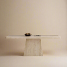 Front view of Ardella sintered stone dining table with trapezoid base and minimalist beige studio background