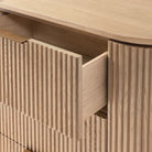 Close up of the Arden dresser with a drawer open, showing the solid wood construction, smooth glides, and ribbed texture detail.