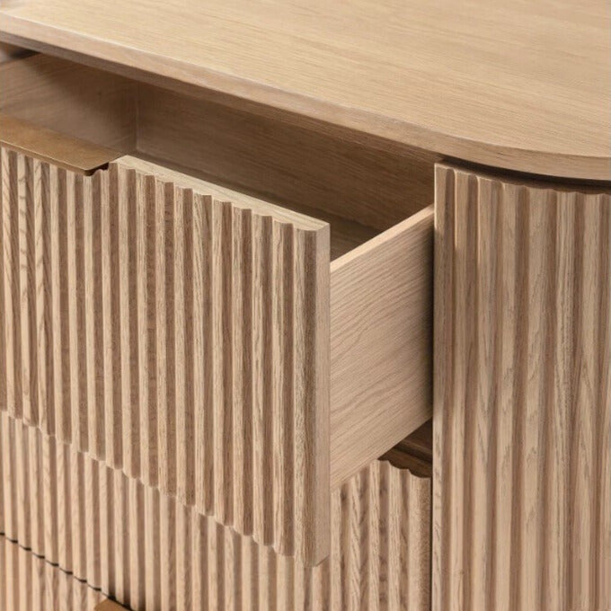 Close up of the Arden dresser with a drawer open, showing the solid wood construction, smooth glides, and ribbed texture detail.