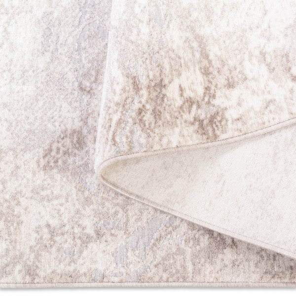 Folded corner of the Aria abstract soft-touch rug showing the soft top pile and durable woven backing construction.