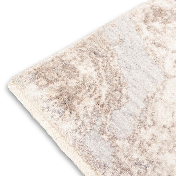 Corner view of the Aria abstract soft-touch rug highlighting its modern marbled pattern in cream, beige, and grey.