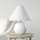 Arlo White Marble Sphere Table Lamp on round wooden side table beside cream armchair in minimal neutral living space