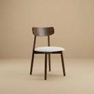 Ash Classic dining chair featuring a solid wood frame with a dark walnut finish, curved backrest, and cream upholstered seat.