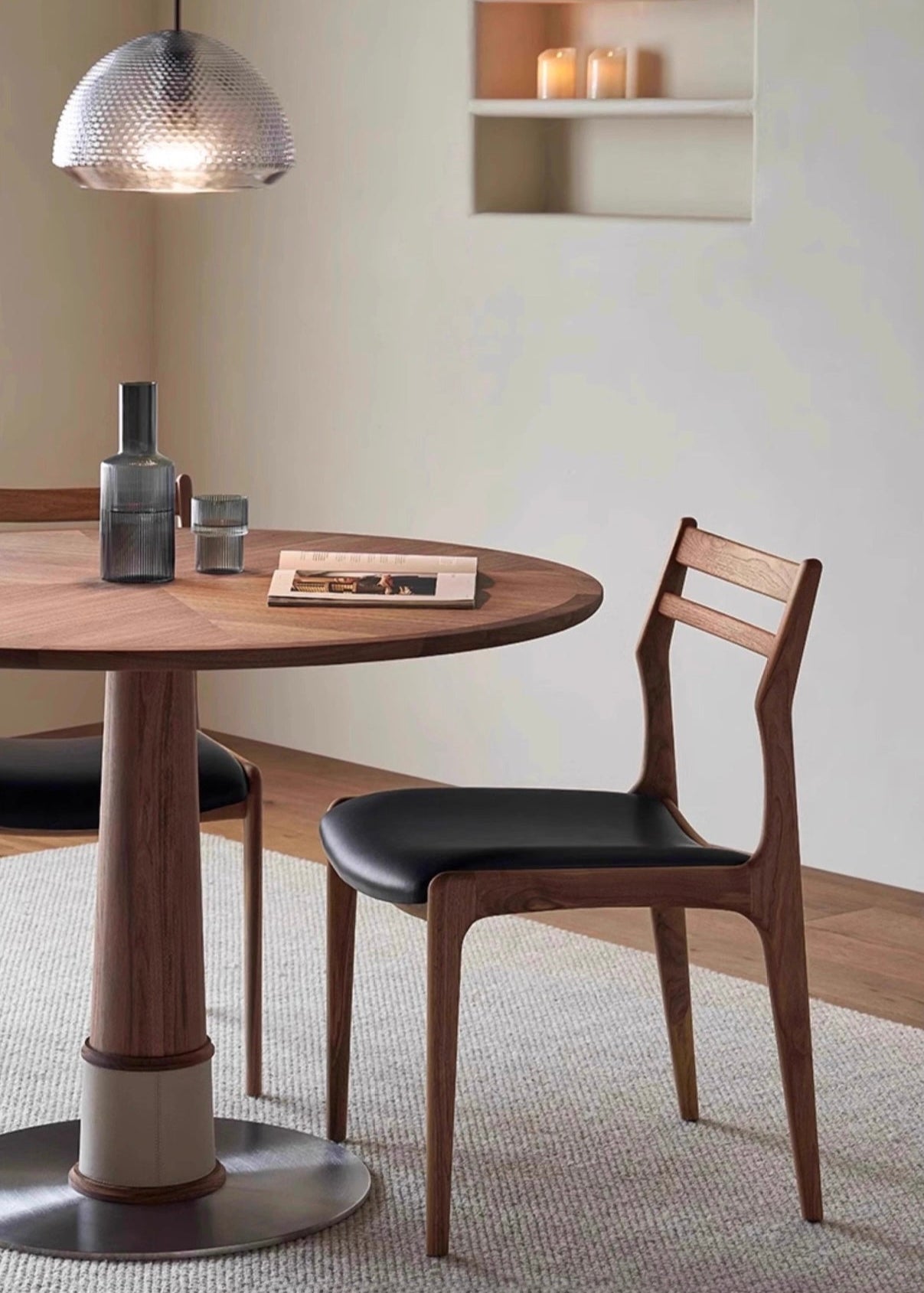 Aspen Classic Dining Chair with black leather seat and curved solid wood frame beside a round dining table