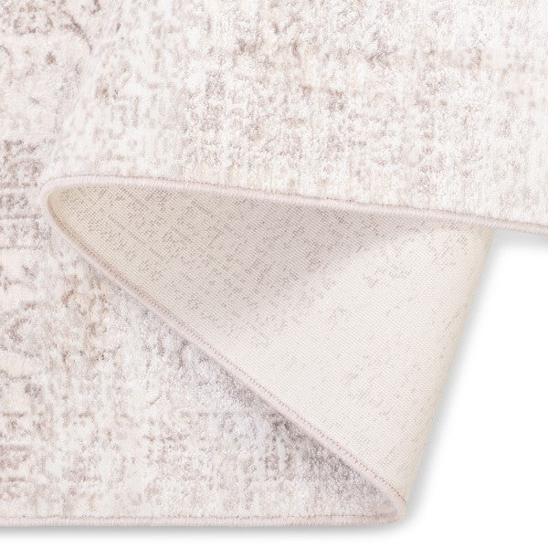 The Audrey traditional rug folded over to show its soft-touch pile and sturdy woven backing.