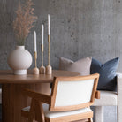 Aurelia Candle Holders styled on round wood dining table with ceramic vase and neutral decor