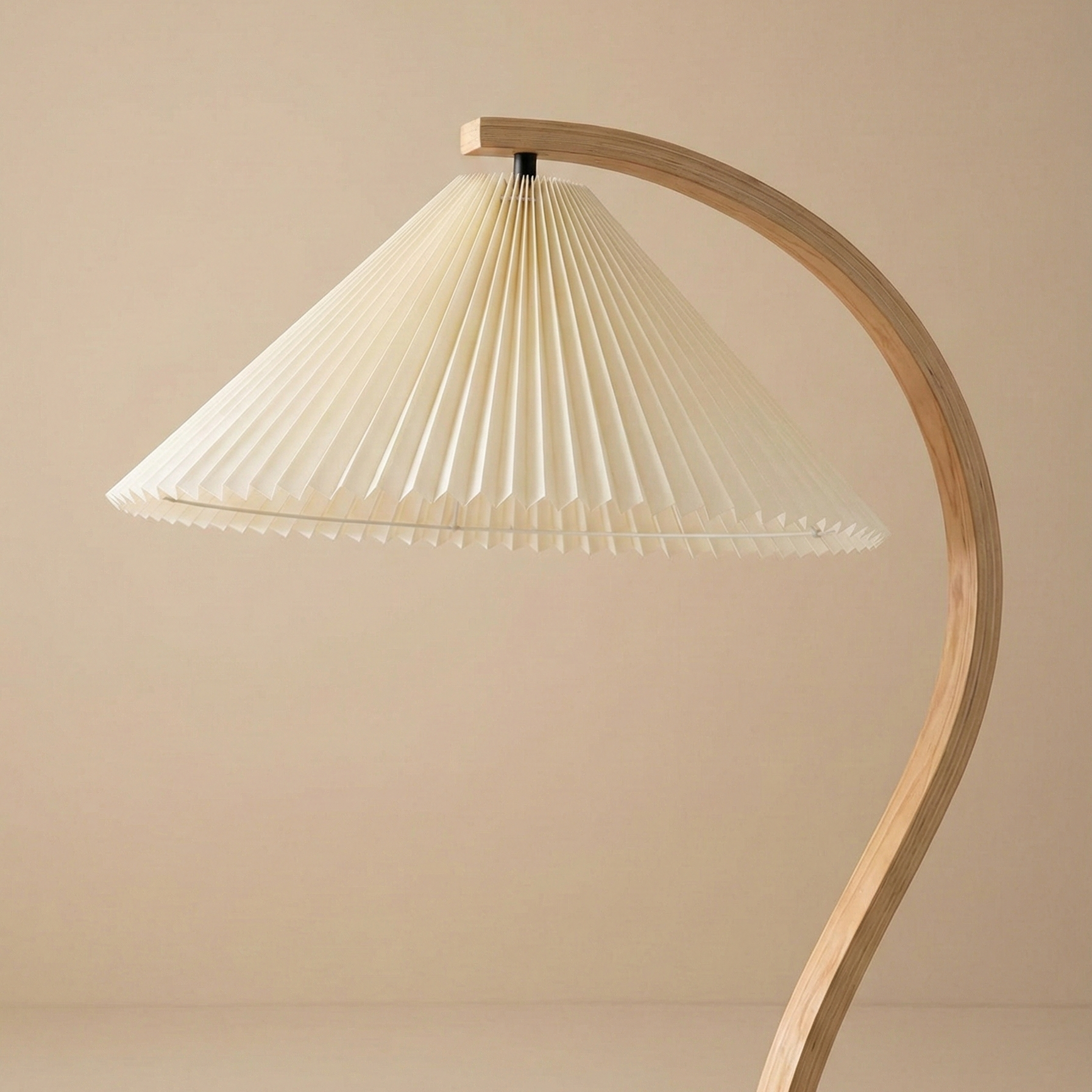 Close up of the Bianca floor lamp showing the detailed cream pleated shade and the smooth grain of the curved wooden arm.