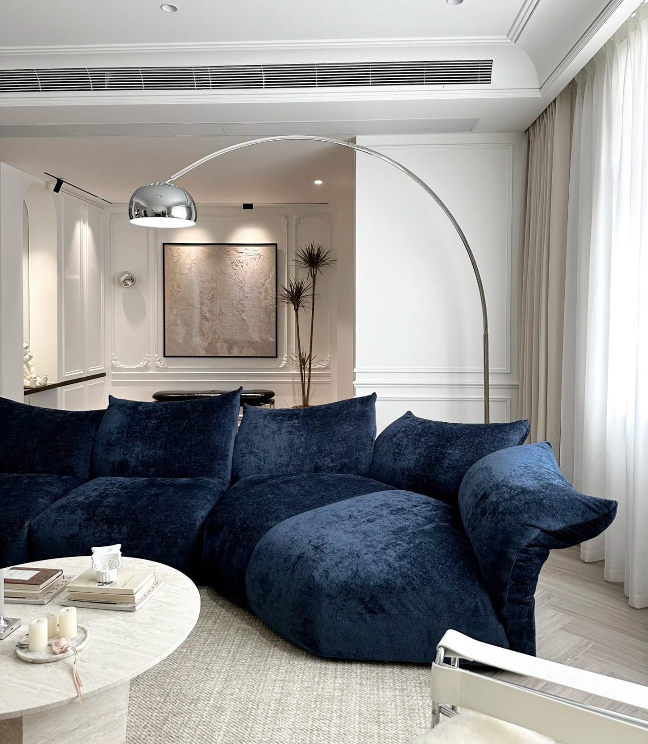 Close-up of Blooming Embrace Modular Sofa in navy blue fabric featuring deep seating and soft cushions in a modern living room setup