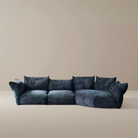 Blooming Embrace Modular Sofa in deep blue fabric with plush cushions and curved silhouette on beige studio background