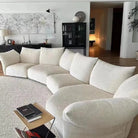 Blooming Embrace Modular Sofa in white fabric styled in a modern living room with neutral tones, round rug, and abstract wall art