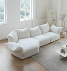 Blooming Embrace Modular Sofa in soft white fabric displayed in a bright studio setting with herringbone floor and modern decor