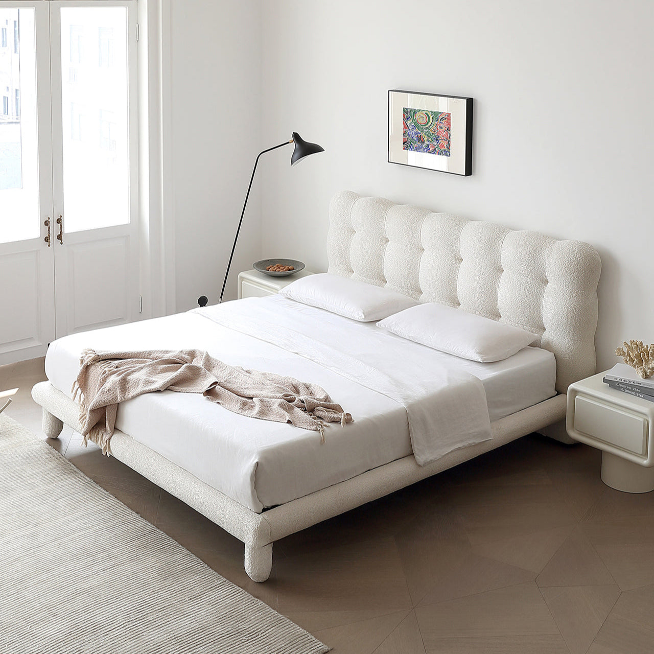 Bubbly Bliss Bed with tufted white boucle headboard and rounded legs in a bright modern bedroom with soft neutral tones