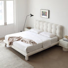 Bubbly Bliss Bed with tufted white boucle headboard and rounded legs in a bright modern bedroom with soft neutral tones