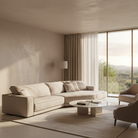 Budapest Lounger in beige fabric set in a minimalist living room with marble coffee table and soft natural light