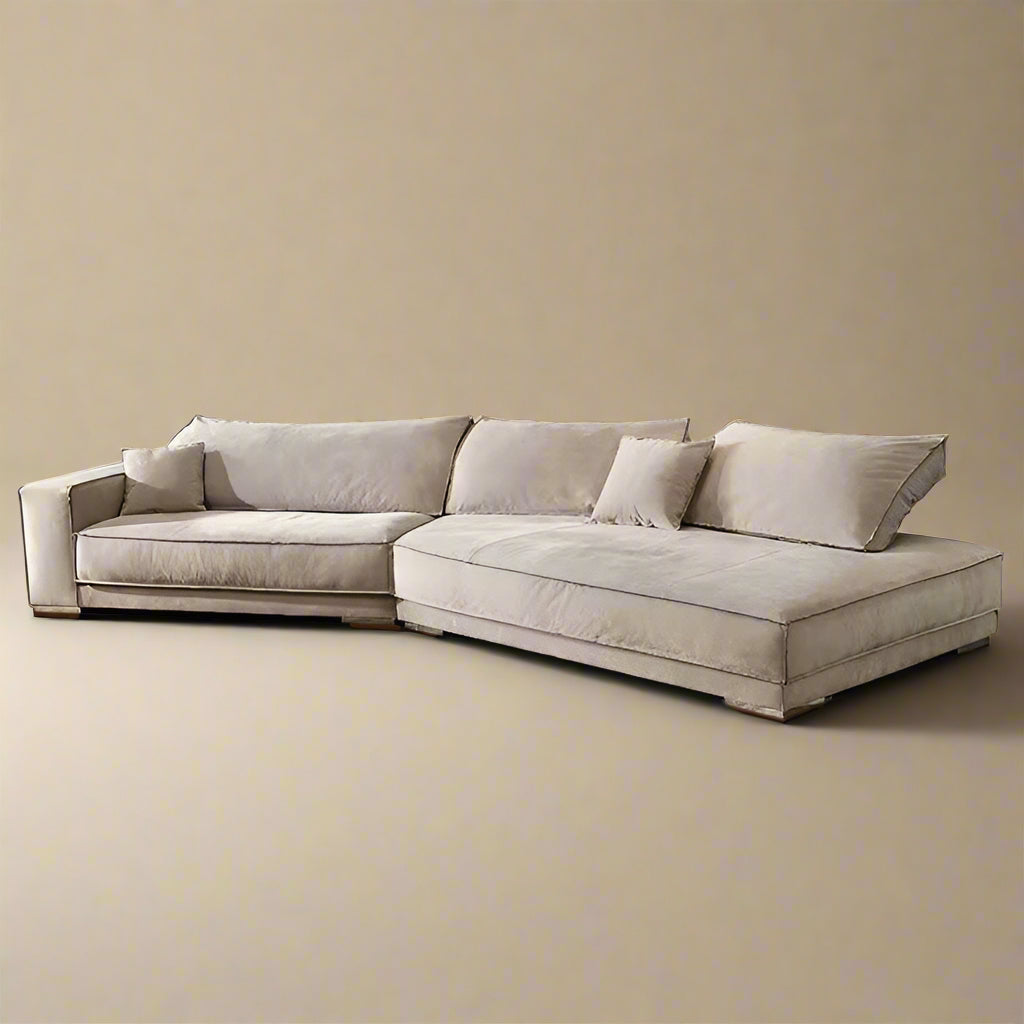 Budapest Lounger in light beige ultra suede fabric with deep cushions and low profile design on a warm beige studio background