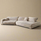 Budapest Lounger in light beige ultra suede fabric with deep cushions and low profile design on a warm beige studio background