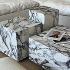 Bulgari Charm Coffee Table in white marble with bold dark veining shown in close-up detail beside cream modular sofa