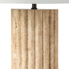 Close-up of Callisto Travertine Table Lamp showing natural fluted stone texture and warm beige surface details