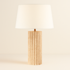 Callisto Travertine Table Lamp with fluted natural stone base and cream fabric shade on beige studio background