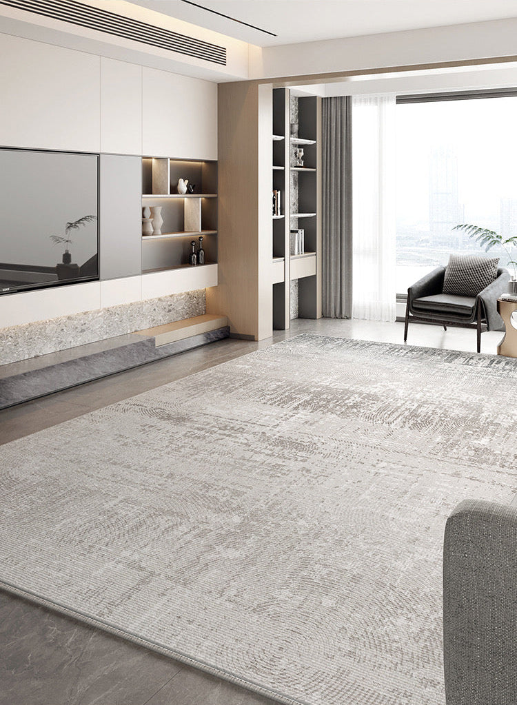 Calm Grey Haven Rug in a modern bright living room with built-in shelving and lounge chair