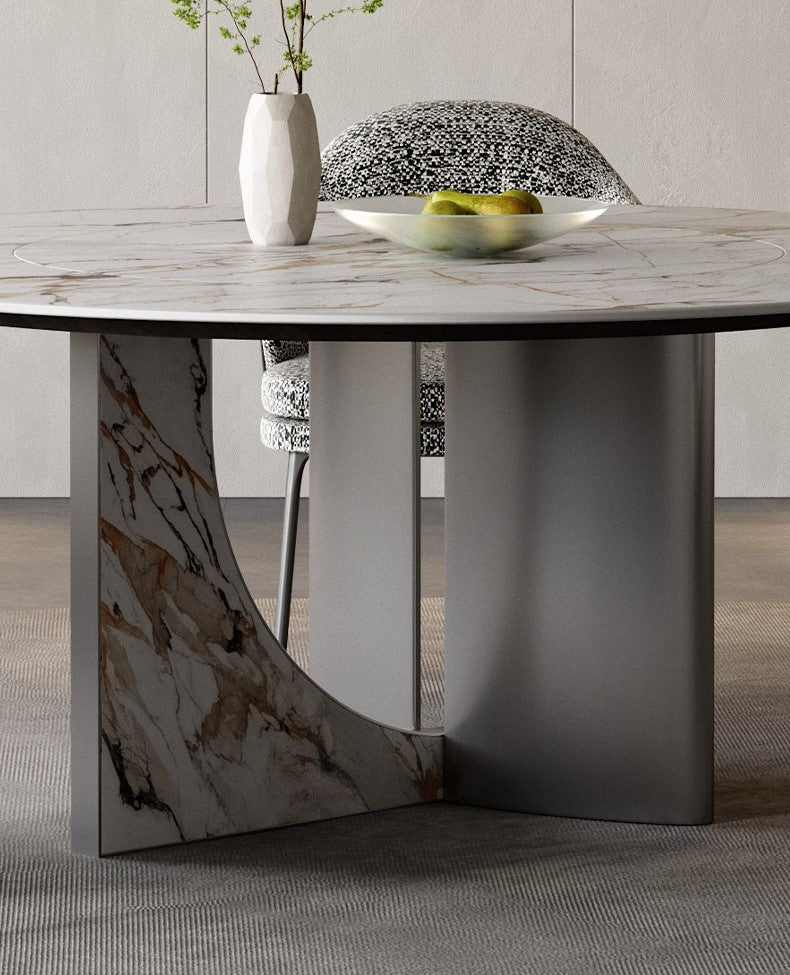 Close-up of Celesti Elegance round dining table showcasing marble-patterned top and stainless steel cross base with artistic detailing
