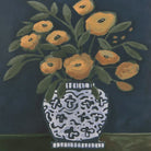 Close-up of the Clementine wall art featuring a painted still life of orange flowers in a blue and white patterned vase