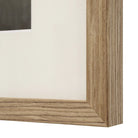 Macro close-up of the natural light wood frame and crisp white matting on the Clementine floral wall art.