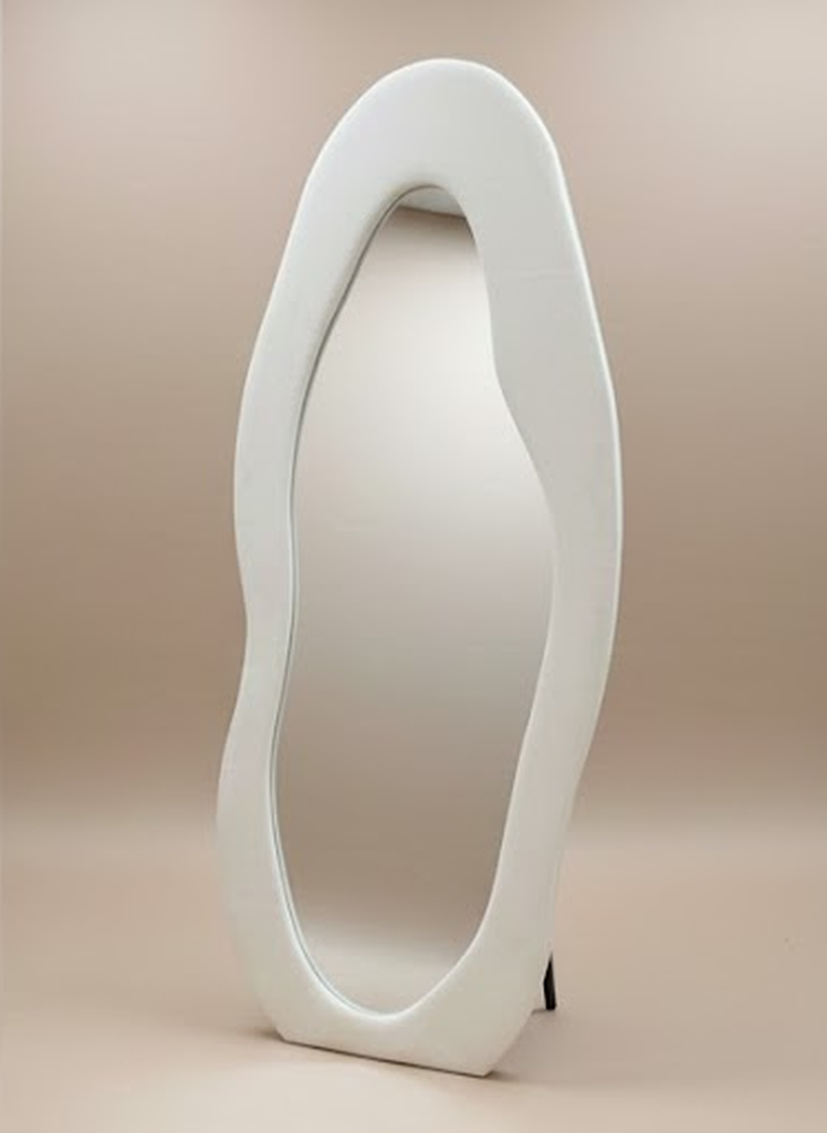 Cloud-shape full body mirror with an irregular white wavy frame, angled view on beige background.