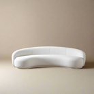 Contour Bliss Bouclé Sofa with curved silhouette in white bouclé fabric on beige studio background