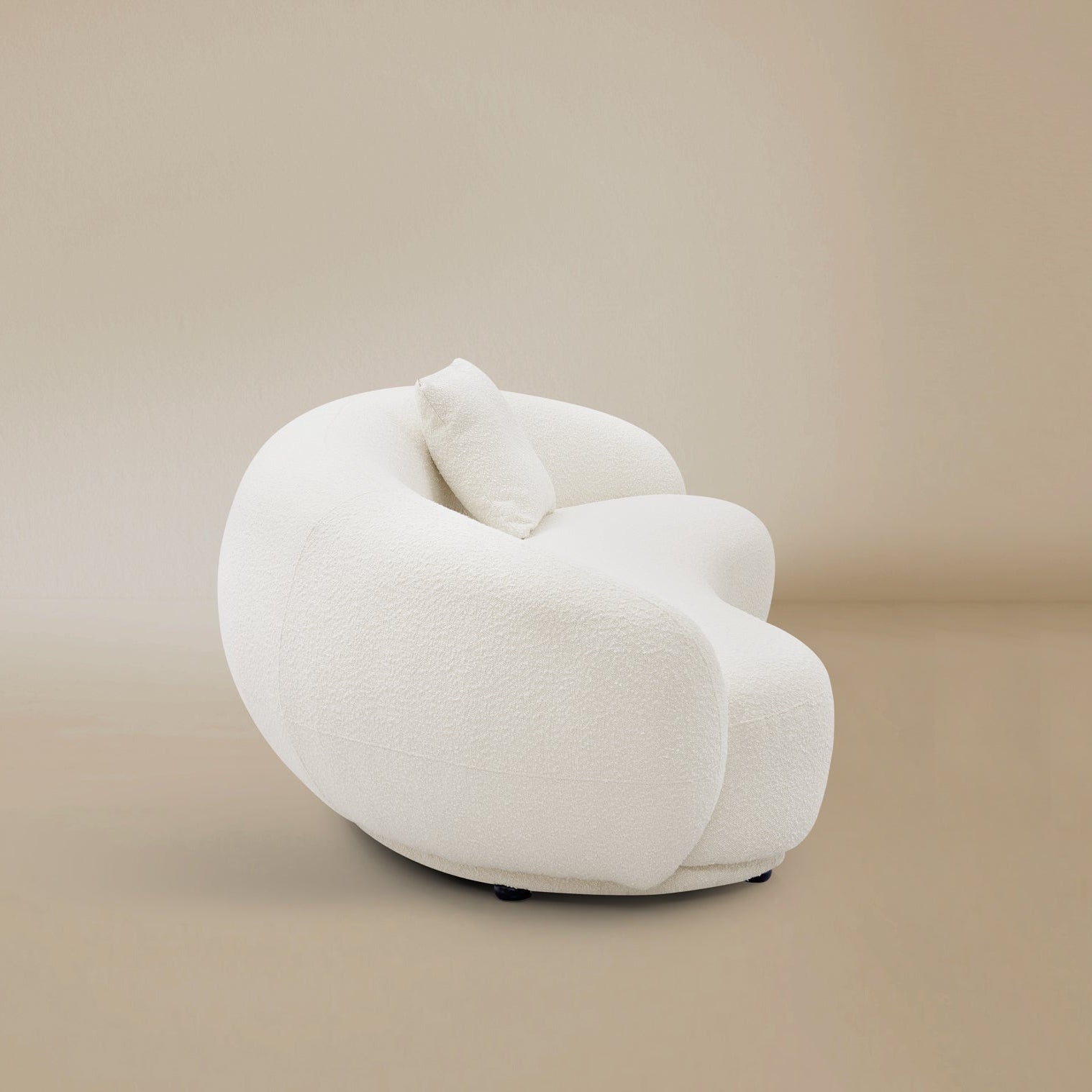 Side view of the Contour Bliss Boucle Sofa on a beige background