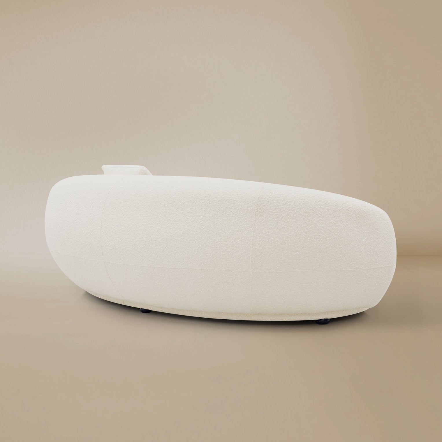 Side view of the Contour Bliss Boucle Sofa in a beige background