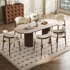Crescent Grove Dining Table styled in an elegant dining room with cream chairs and decorative accents on top